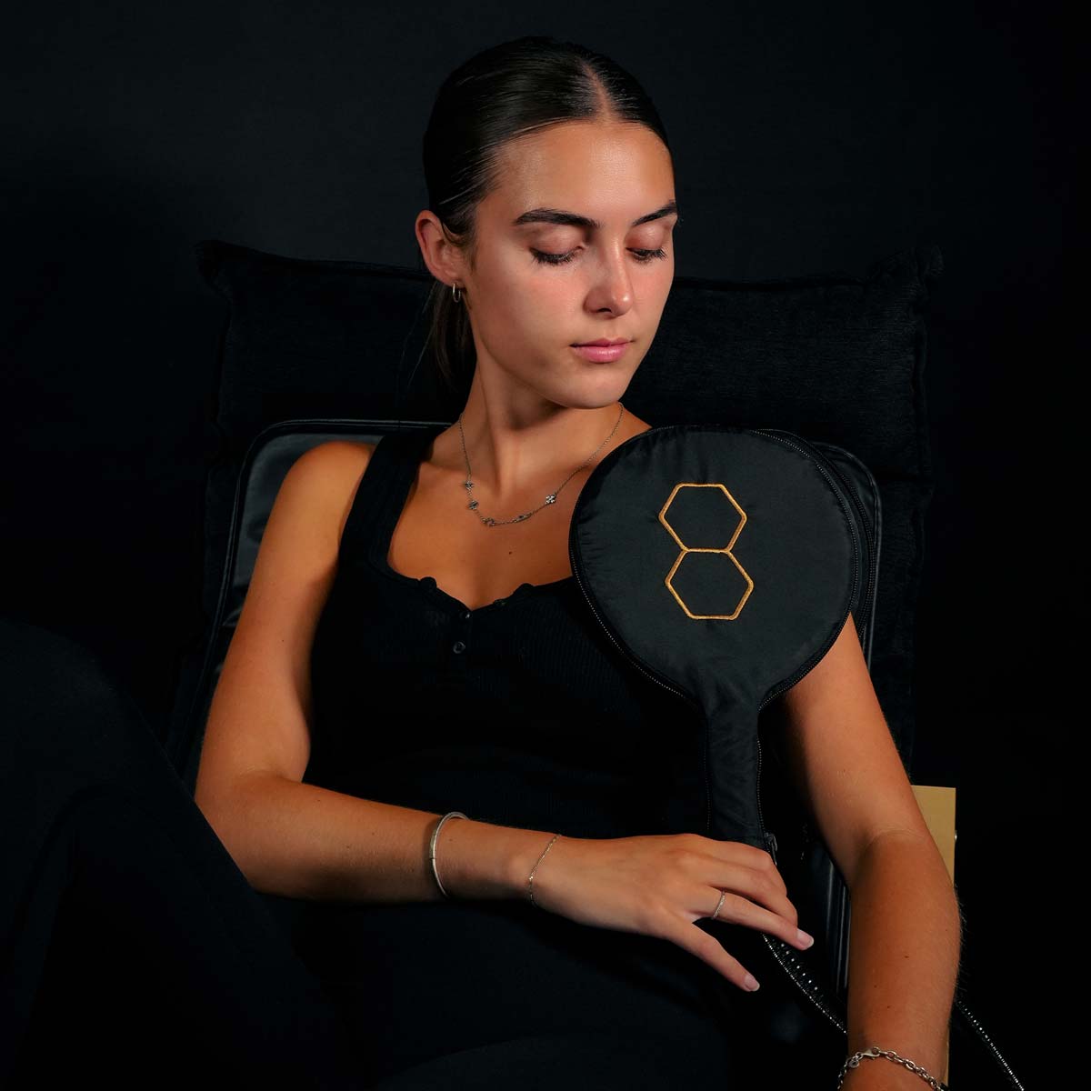Women applying dual small loops in sandwich effect to shoudler