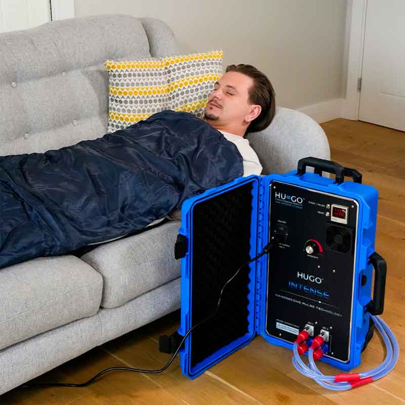 Man laying on sofa using the HIGO Intense full body mats